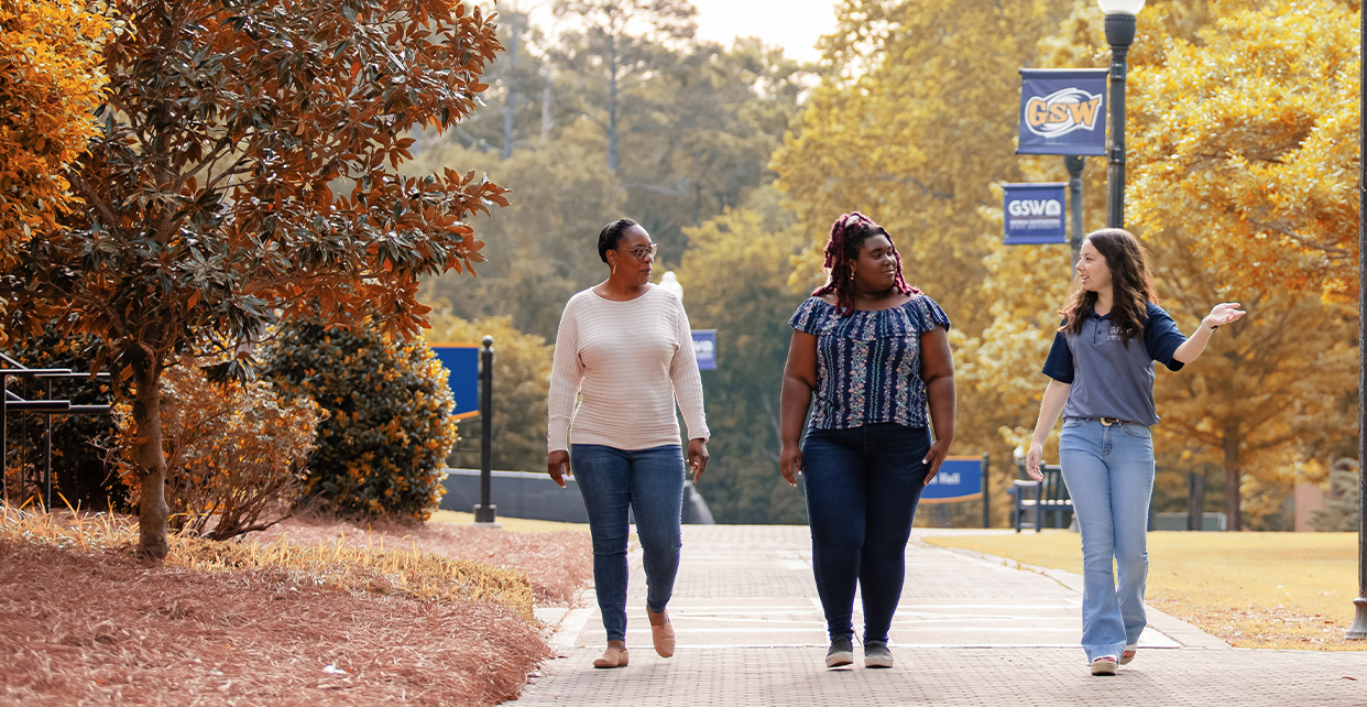 Student walking around campus during fall