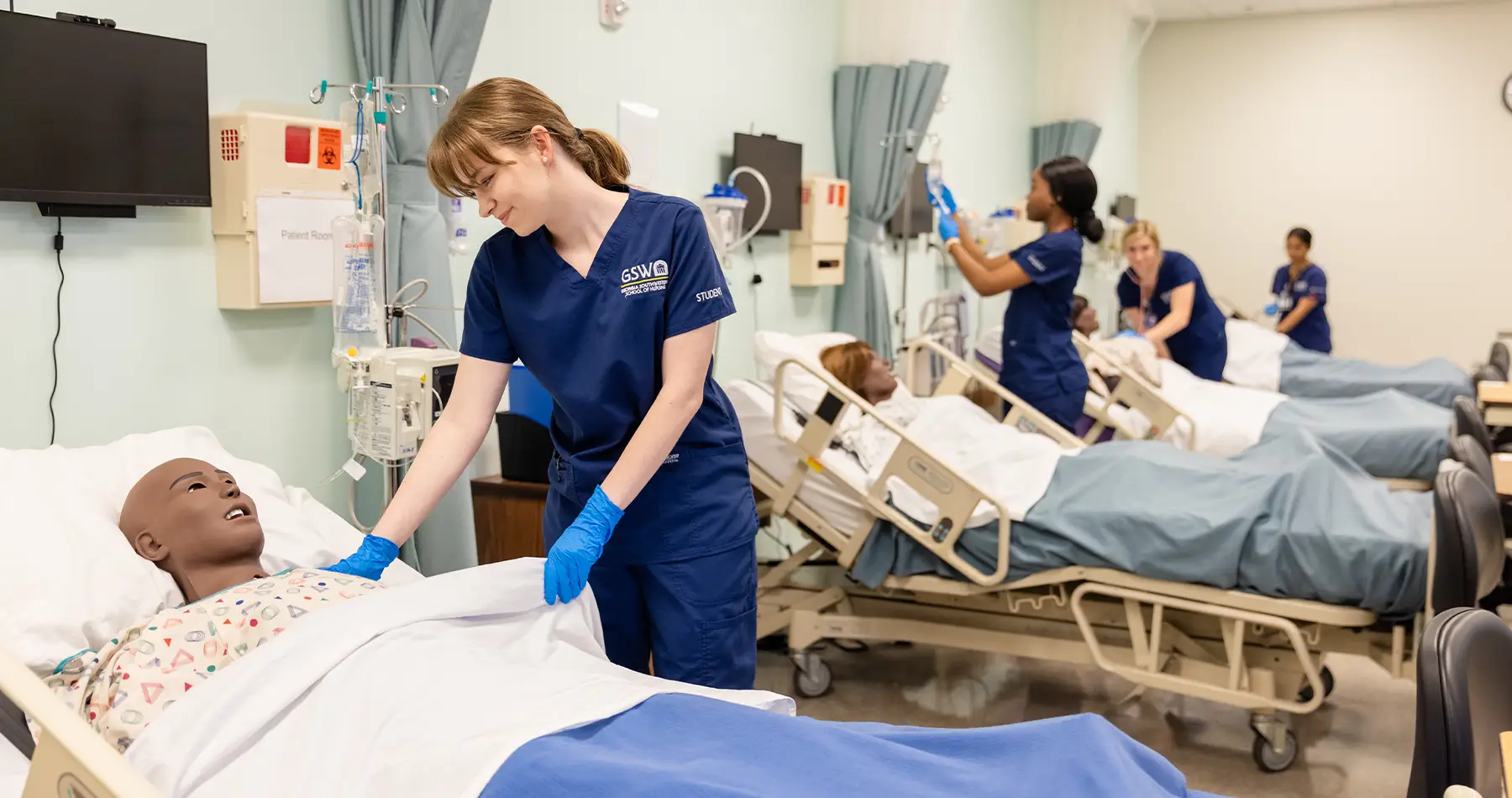 Nursing students practicing with simulations