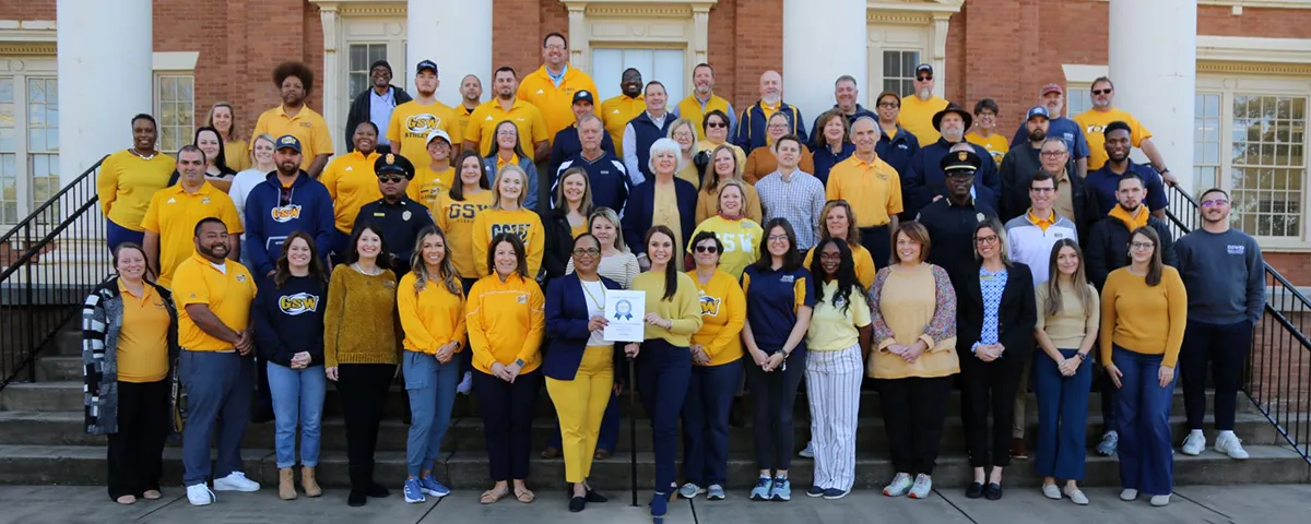 GSW employees wear blue and gold in group photo