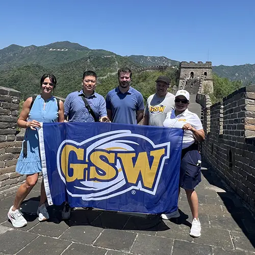 group holds GSW flag on Great Wall of China