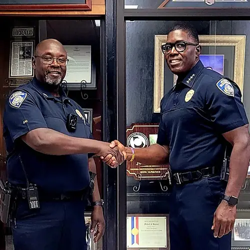 Sgt. Barron is congratulated by Chief Lewis