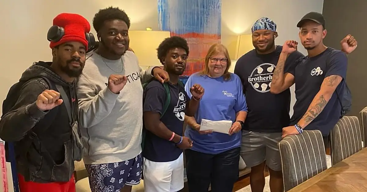 Brotherhood members present check to CASA representative